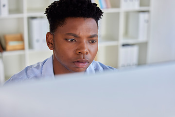 Image showing Serious, black man and business analyst at a office computer reading digital data. Businessman, research and financial project planning of a startup employee working and thinking of web decision
