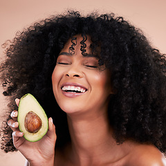 Image showing Black woman, studio and avocado for beauty, smile and skincare with health, wellness and self care by background. Happy gen z model, african and fruit for natural aesthetic, healthy nutrition or diet