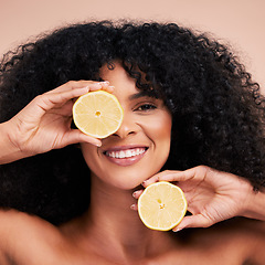 Image showing Face portrait, hair care and black woman with lemon in studio isolated on a brown background. Fruit, skincare and happy female model with lemons for healthy diet, nutrition or vitamin c and minerals.
