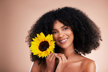 Image showing Black woman, studio portrait and sunflower with smile, beauty and cosmetic wellness by beige background. African gen z model, flower and spring aesthetic with happiness, makeup and natural makeup