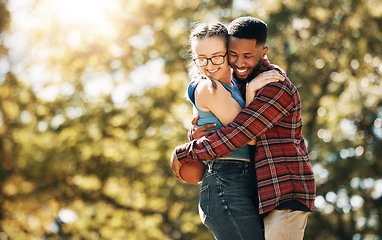 Image showing Football, love and interracial couple with a hug in nature for sports, playful and bonding. Affection, happy and black man and woman hugging for rugby, sport and playing with mockup space in a park