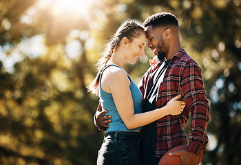 Image showing Interracial couple, outdoor park and love with a hug for commitment, care and nature in summer. Black man and woman together for support, security and date for quality time with trees and lens flare