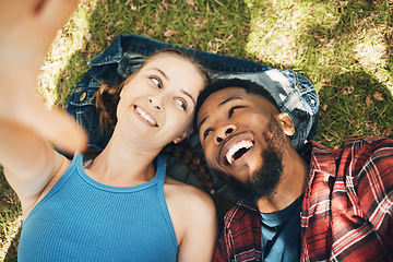 Image showing Interracial couple, park selfie and lying on grass with smile, love and happiness to relax on holiday. Black man, woman and profile picture on lawn for social media app with romance, above and care