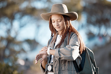 Image showing Woman, tourist and checking watch in hiking, adventure or backpacking journey in the nature outdoors. Female hiker looking at wristwatch for travel, time or mountain trekking in performance check