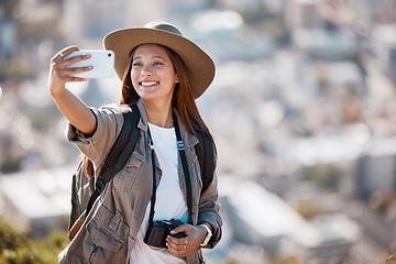 Image showing Woman, tourist and smile for travel selfie on hiking adventure, backpacking journey or profile picture in nature. Female hiker smiling for photography, memory photo or scenery in mountain trekking