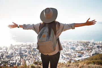 Image showing Woman, tourist and hiking or travel in city for freedom, adventure or backpacking journey on mountain in nature. Female hiker with open arms enjoying fresh air break, trekking or scenery of Cape Town