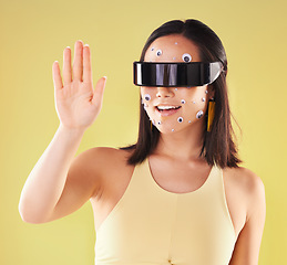 Image showing Virtual reality, 3d metaverse and woman in vr, exploring cyber world or futuristic tech. Future, face stickers and happy female with digital headset for gaming in studio isolated on yellow background