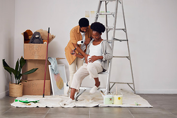 Image showing Painting, pregnancy or home with a black couple in DIY, renovation or house remodel with a paintbrush or roller. Teamwork, partners or African man and pregnant woman excited about baby or new family