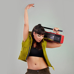Image showing Dance, trendy and woman with a radio for music isolated on a grey studio background. Party, fashion and dancing girl holding a cassette stereo listening to audio, boombox record and track with rhythm