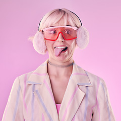 Image showing Fashion, comic face and a woman quirky in studio with tongue out on a pink background. Aesthetic model person with funny glasses for edgy vaporwave trend with creativity, comedy and color for art
