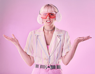 Image showing Confused, angry and portrait of a woman with fashion isolated on a pink background in a studio. Anxiety, sad and stylish girl model wearing ear muffs while frustrated with anger and a problem
