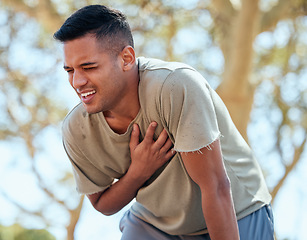 Image showing Man, runner and heart attack pain in nature while running outdoors for health or wellness. Sports, cardiovascular emergency or male athlete with painful asthma, stroke or cardiac arrest after workout