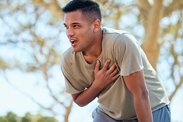 Image showing Man, runner and heart attack pain in nature while running outdoors for health and wellness. Sports, emergency thinking and male athlete with painful chest, stroke or cardiac arrest after workout.