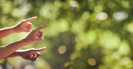 Image showing Hands, finger and pointing sign on nature mockup for product placement, advertising or marketing. Hand of group showing fingers in point for location, direction or sightseeing outdoors on bokeh