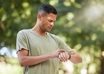 Image showing Fitness, time and man with watch in nature to check heart, running progress and notification. Sport, exercise and athlete runner reading health, pulse or tracking training on technology in Australia