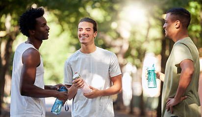 Image showing Fitness, friends and men in park with water, relax and talking on break from running or outdoor exercise together. Nature, workout and health, group of people rest and drink during sports training.