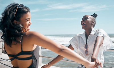 Image showing Holding hands, friends and women dance at beach, having fun and laughing together outdoors. Comic, freedom and girls laugh at funny comedy or joke, dancing and enjoying time at promenade seashore.