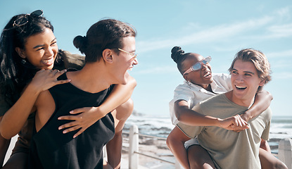 Image showing Couple of friends, laughing and piggyback by beach, ocean or sea in social gathering, group vacation comedy or summer holiday. Smile, happy and diversity men carrying women in travel, bonding or game