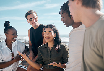 Image showing Woman, talking and bonding people by beach, ocean or sea in group social gathering, holiday community or summer storytelling. Smile, happy and diversity friends in travel location, relax or freedom