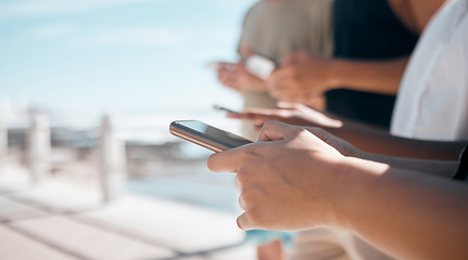 Image showing People, hands and phone in networking at beach chatting, texting or social media together in the outdoors. Hand of group on smartphone for communication, typing or data sharing mobile app on mockup