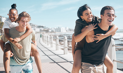 Image showing Diversity men, laughing and piggyback by beach, ocean or sea in social gathering, group vacation comedy or summer holiday. Smile, happy and couple of friends carrying women in travel, bonding or game