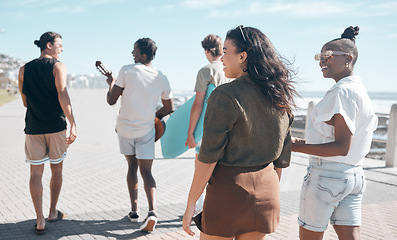Image showing Diversity, walk and friends on beach promenade while on summer vacation or weekend trip together. Friendship, multiracial and group of people people walking, bonding and talking by ocean on holiday.