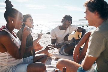 Image showing Couple of friends, playing and guitar by beach, ocean or sea in holiday vacation, summer travel or social gathering. Smile, happy and bonding diversity people with musical instrument in relax picnic