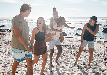 Image showing Friends, laughing or piggyback by beach, ocean or sea in social gathering, group vacation comedy or summer holiday. Smile, happy or diversity men carrying women in travel fun, bonding or comic games