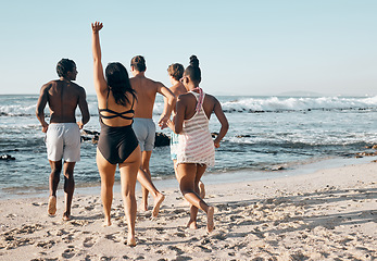 Image showing Bonding people, swimwear or running to sea, ocean or beach water on summer holiday, fun vacation or relax travel break. Men, women or diversity friends in swimsuit for diversity freedom or swimming