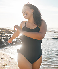 Image showing Swimsuit woman, laughing and playing by beach, ocean or sea water in summer holiday, relax vacation or travel in body confidence. Smile, happy and fun student in swimwear for normal figure or shape