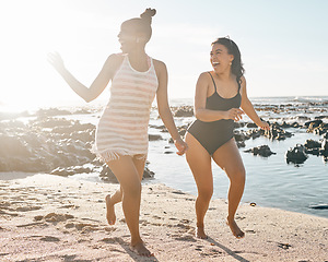 Image showing Laughing women, swimsuit and running by sea, ocean or beach water on happy summer, comic holiday or bonding travel. Black people, students and friends in swimwear for freedom, swimming or funny games