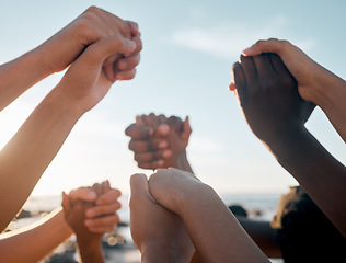 Image showing Friends, bonding and holding hands on beach community trust support, social gathering or summer holiday success. Men, women and diversity people in solidarity, team building or travel mission goals