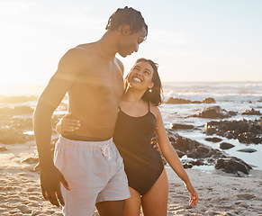 Image showing Happy couple, bonding or swimsuit hug on sunset beach in relax romance holiday, love vacation date or summer location. Smile, black woman or man in swimwear embrace, freedom trust or travel support