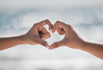 Image showing Hands, heart and couple with love, peace and unity sign on mockup, space or blurred background. Hand, emoji and finger shape by man and woman at a beach for travel, vacation or summer trip in Bali