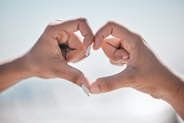 Image showing Hand, heart and couple with love, peace and unity sign on mockup, space or blurred background. Hands, emoji and care finger shape by man and woman bonding on travel, vacation or summer trip in nature