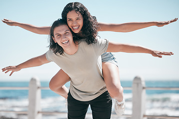 Image showing Freedom, travel and portrait of piggyback couple at beach, happy and playful against blue sky background. Face, airplane and fun woman with man on vacation, holiday or summer trip in Mexico together