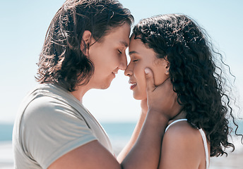 Image showing Love, hands on face and couple relax at a beach, in love and romantic on blue sky background. Intimate, moment and romance by man with woman on ocean trip, sweet and calm relationship moment in Bali