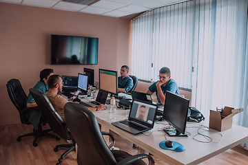 Image showing Programmers engrossed in deep collaboration, diligently working together to solve complex problems and develop innovative mobile applications with seamless functionality.