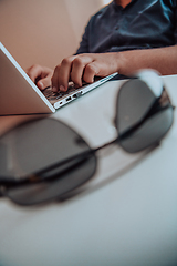 Image showing Close-up photo of a programmer typing on a laptop