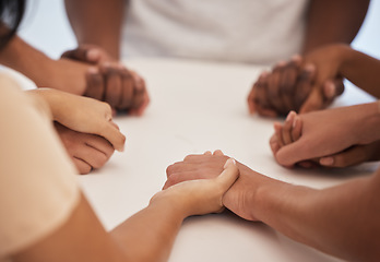 Image showing Holding hands, praying and people worship for peace, trust or faith in God at a table together. Pray, Christian and community by group hand in prayer, praise or blessing while united in Jesus Christ