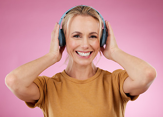 Image showing Headphones, woman and portrait on pink background, wall backdrop or studio mockup. Happy female model listening to music, sound media and streaming audio connection, face and hearing podcast on radio