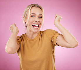 Image showing Excited, winner and winning mature woman cheering for a prize isolated against a pink studio background happy and smile. Portrait, celebration and older female celebrate win feeling cheerful