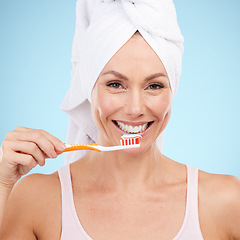 Image showing Portrait, woman smile and toothbrush isolated on blue background for dental, mouth or orthodontics health. Beauty model or mature person for brushing teeth, cleaning product and toothpaste in studio