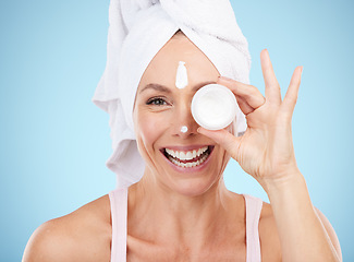 Image showing Lotion, jar and beauty portrait of woman for face, smile or cosmetics on mockup blue background. Facial cream, skincare and model with container of sunscreen, wellness or advertising aesthetic makeup