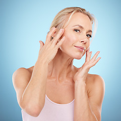 Image showing Woman touch face for beauty, skincare and blue background for wellness, cosmetics and salon spa results. Portrait, facial and studio model with healthy aesthetic, laser dermatology and natural shine