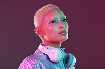 Image showing Cyberpunk fashion, black woman and headphones in studio, holographic clothes and vaporwave style. Futuristic model, young gen z and listening to music with retro aesthetic, audio technology and neon