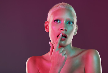 Image showing Neon, beauty and woman with finger on lips, makeup and lights for creative advertising on studio background. Cyberpunk, product placement and model isolated for skincare and futuristic mock up space.