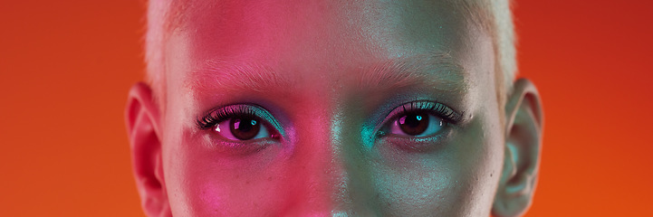 Image showing Makeup, cyberpunk and portrait of the eyes of a woman isolated on an orange background in a studio. Edgy, creative and banner of the face of a trendy model with cosmetics, glamour and eyeshadow