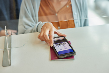 Image showing Hands, phone and passport with digital ticket at airport for travel, immigration or transport service on table. Hand of traveler showing smartphone boarding pass, barcode or permit on mobile app