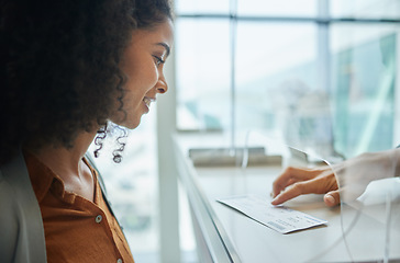 Image showing Ticket, glass window and black woman at airport or theatre with paper for travel or box office service. Customer person at cashier consultant booth counter for work booking and buying pass at seller